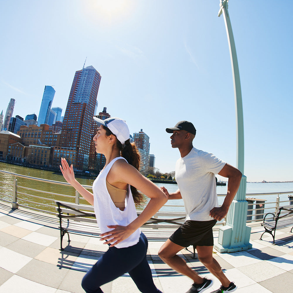 A man and a woman run on the waterfront 